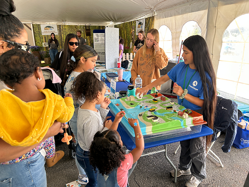 ACUA/Watershed Ambassador demonstrates how street pollution affects waterways.