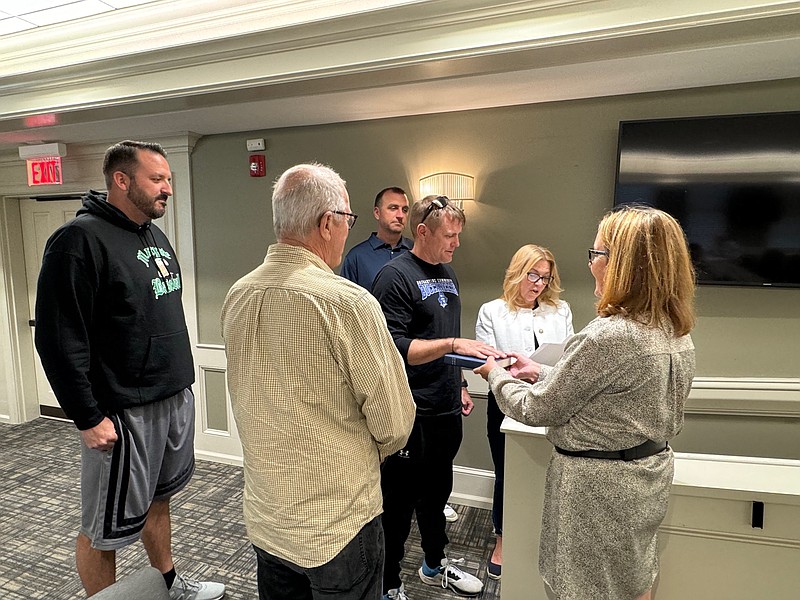 City Clerk Johanna Casey holds the Bible while Commissioner of Public Safety Cathy Horn swears in members of the city's Lifeguard Pension Board, from left, Brian Hiltner, Richard Patterson, Charles Collins, and Greg Smallwood, taking the oath of office.