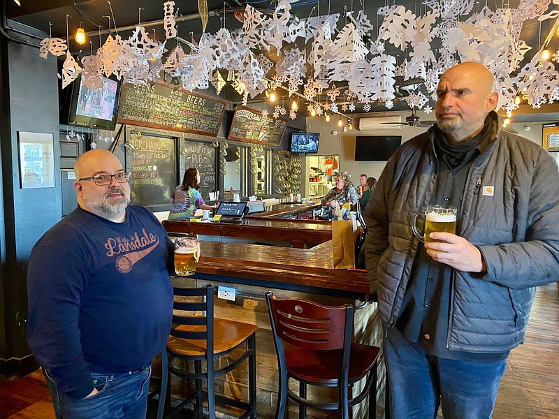 Round Guys co-owner Scott Rudich, left, discusses beers and cheesesteaks with Lt. Gov. John Fetterman, right. 