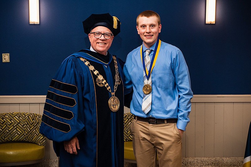 Dr. Chris Domes, Neumann University president, and Jake Loburak, 2022 valedictorian. 