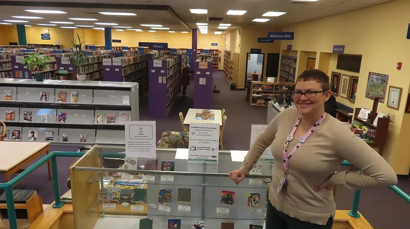 New Lansdale Public Library Director Shira Pilarski poses next to a display case in the library on Tuesday, Sept. 26, 2023. 