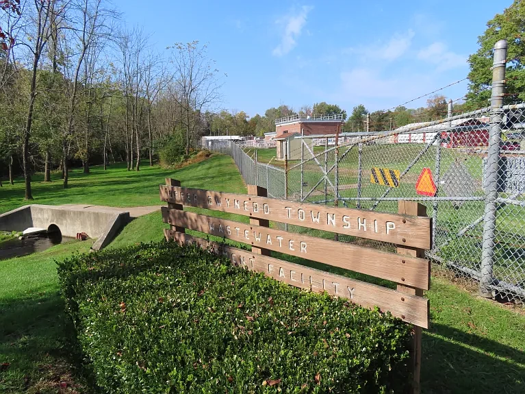 A creek runs past the entrance to the Upper Gwynedd Wastewater Treatment Plant on Friday, Oct. 15, 2021. 