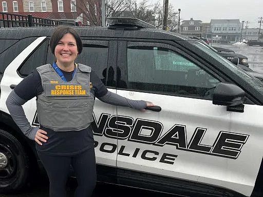 Alexis Moyer, Lansdale’s mental health co-responder, poses with a Lansdale Borough Police Department SUV. 