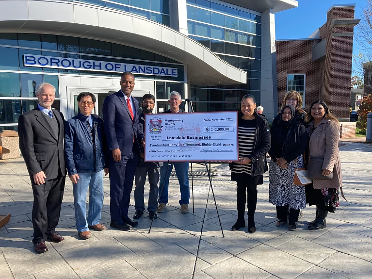 The Montgomery County Recovery Office presents a check of nearly $250,000 in American Rescue Plan Act funds to 15 small business owners in Lansdale as