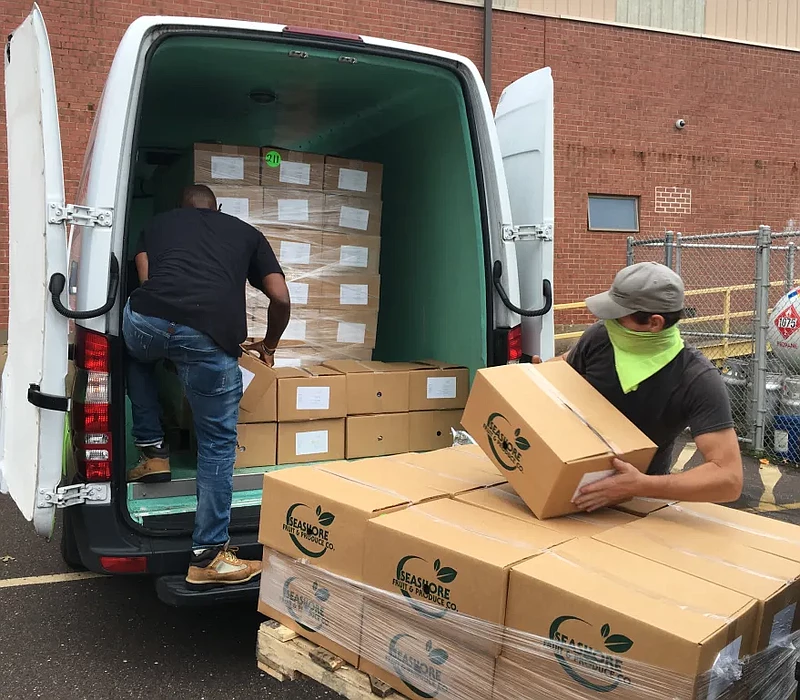 MontCo Anti-Hunger Network Food Resource Driver, Ron Levine, left, and Lansdale Warehouse Company Maintenance Assistant, Steve Wheeler, right, load US