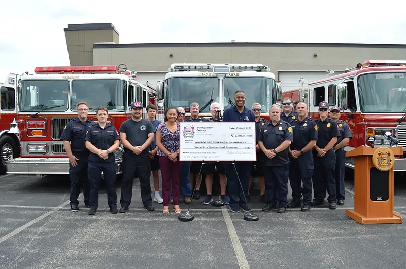 Firefighters and Montgomery County Commissioners gather for a photo on Aug. 3, 2023 outside the Montgomery County Special Operations Substation and Lo