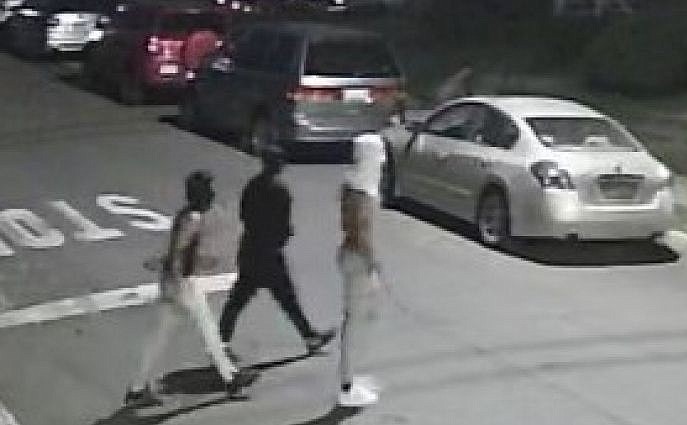 Three unidentified suspects, as seen on surveillance footage. 