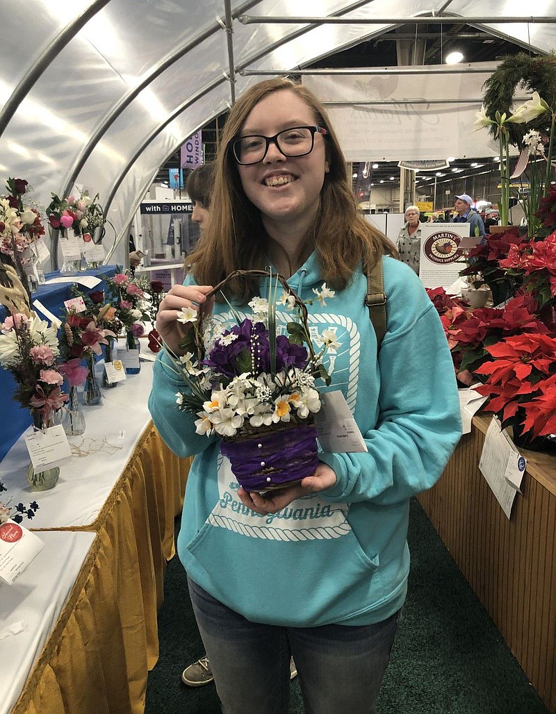 Kayla Bauman, with her first place silk flower design entry. 