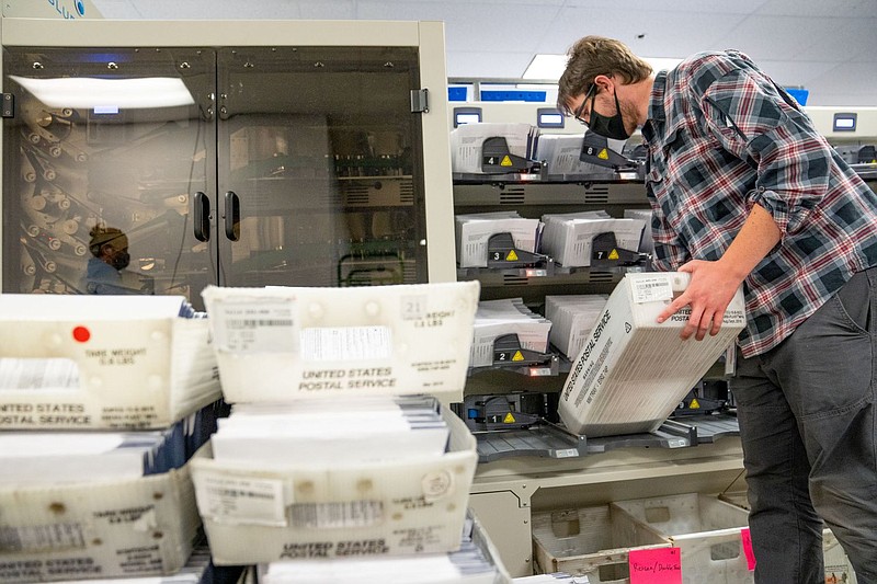A worker organizes mail ballots in Chester County. Pennsylvania counties have been flooded with mail ballot requests, and the days-long process of cou