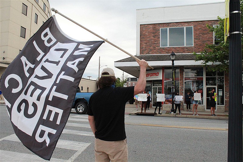 A demonstrator holds a Black Lives Matter sign during a solidarity rally at Memorial Park in Lansdale on June 7. 