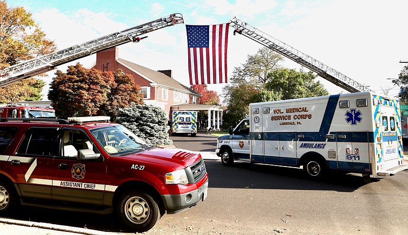 A flag is raised outside of the Huff and Lakjer Funeral Home in Lansdale during Minnick’s funeral services. 