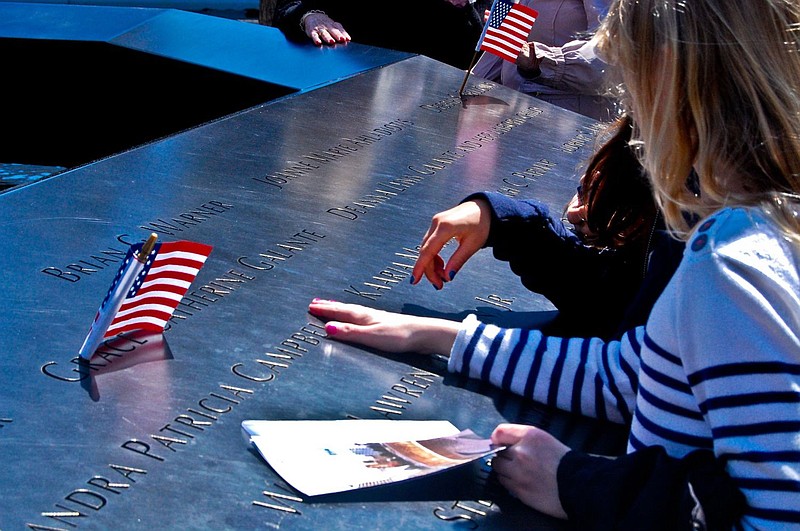 A young girl searches for a name at the September 11 Memorial in New York City in April 2012. 