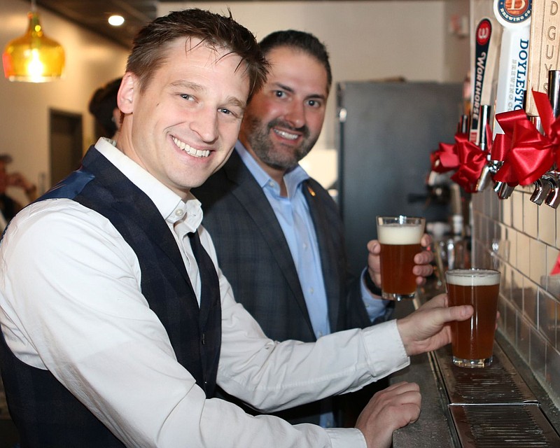 Lansdale Mayor Garry Herbert, left, and state Rep. Steve Malagari, center, perform the ceremonial "first pours" at Local Tap on Nov. 9. 