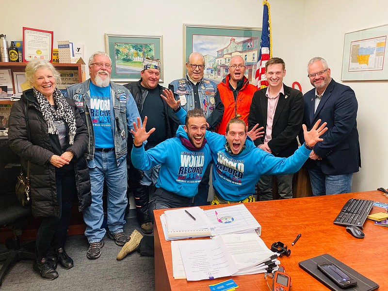 Michael Reid, center left, and Yonatan Belik, center right, pose for a photo Tuesday evening at Lansdale Borough Hall, after breaking the Guinness Boo