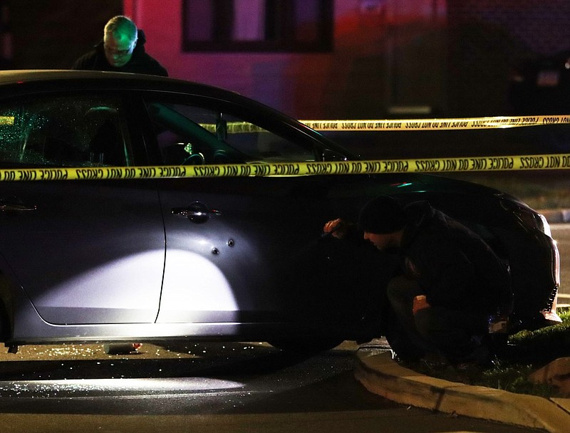 Bullet holes are visible through the passenger side of the victim's vehicle. 