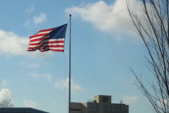 A flag flying in the wind in December. 