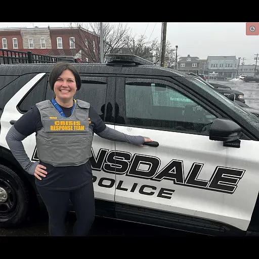 Alexis Moyer, Lansdale’s mental health co-responder, poses with a Lansdale Borough Police Department SUV. 