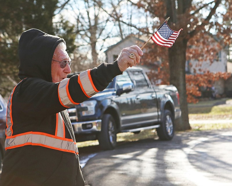 Charles “Chick” Neely, 95, holds an American flag as first responders to pay tribute to his service on his birthday. Neely has been a township residen