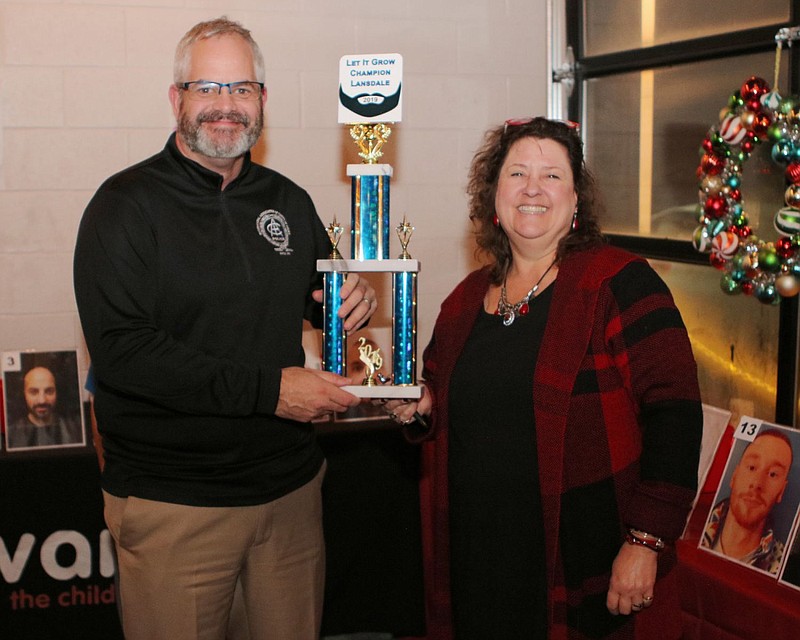 Lansdale Borough Police Chief Michael Trail, left, poses with Mary Fuller, right, and his first place trophy.