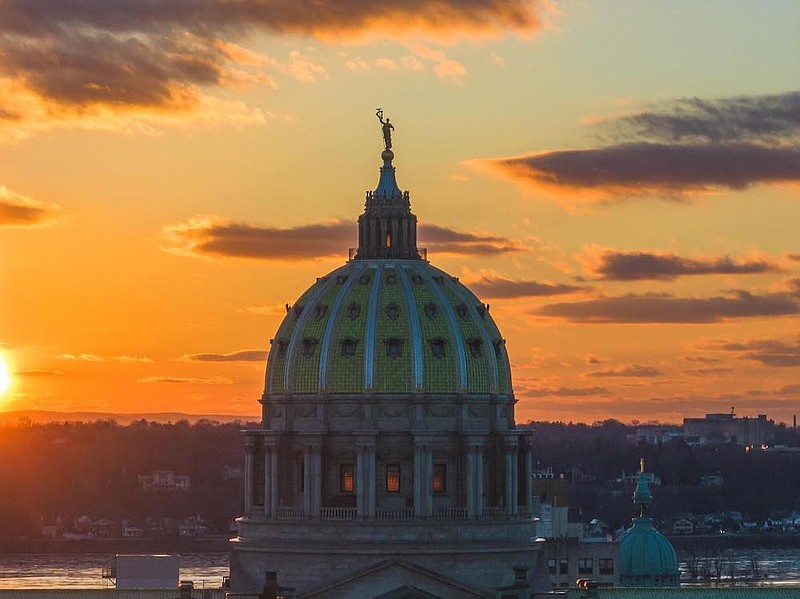 The sun rises over the state Capitol building in Harrisburg, Pennsylvania. 