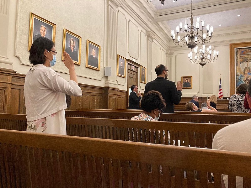 Taking the oath of allegiance at naturalization ceremony 