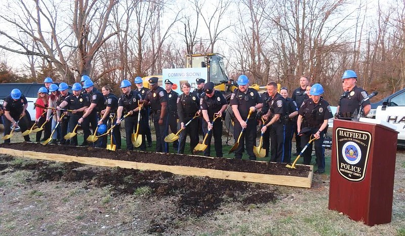 Hatfield Police Department officers lift shovels of soil at the groundbreaking ceremony for the new Hatfield police station on Cowpath Road on Wednesd