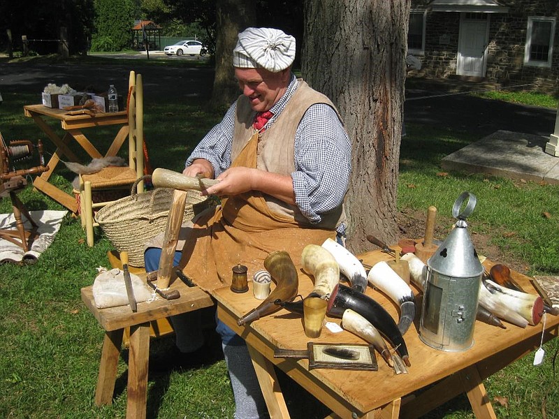 Living history interpreter working on powder horns at Pottsgrove Manor. 