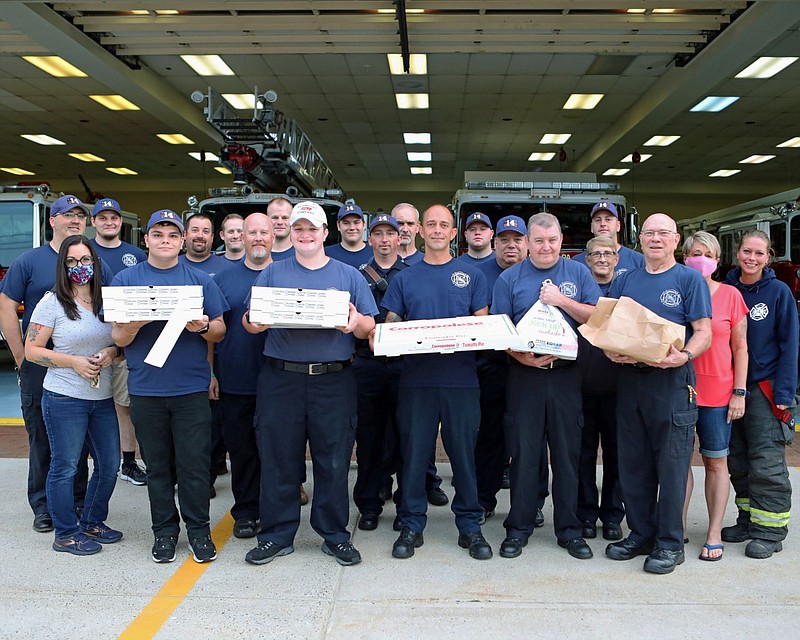 Christina Ottaviano, far left, poses for a photo with members of the Fairmount Fire Company on Sept 9. 