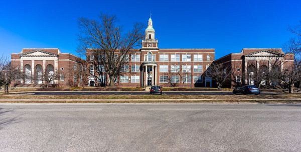 The former David Rittenhouse Junior High School (1928), a three-story Colonial Revival style building in red brick with limestone trim. Prior to being