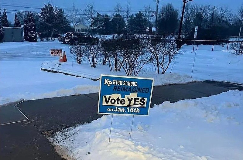 A “Vote Yes” election sign stands in the snow outside the Montgomery Township community and recreation center on Tuesday, Jan. 16, 2024, with a “Vote 