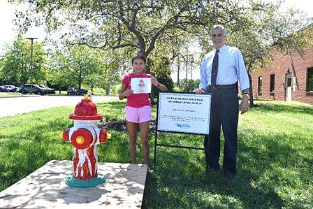 Anthony J. Bellitto, Jr., executive director of NPWA, and Ava Kloufetos with completed hydrant. 