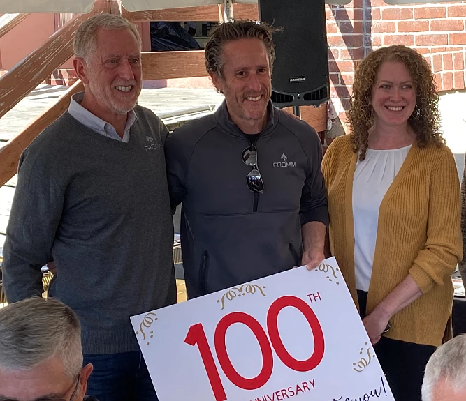 Michael and Lou Fromm, Fromm Electric co-owners, pose for a picture with Souderton Connects board member Kylie Harrington at the company’s centennial 