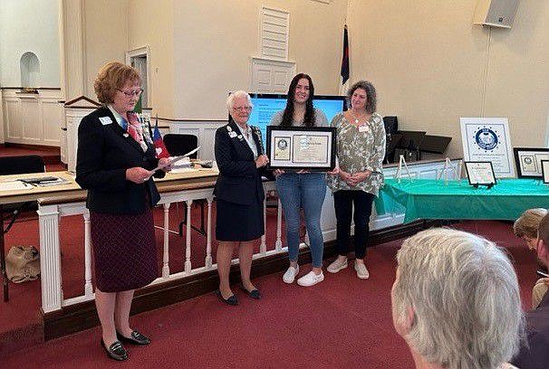 From left: Towamencin Chapter daughters Holly Hayick and Susanne Shaughnessy present Mariah Grace Foote with the DAR Good Citizen award, as her mother