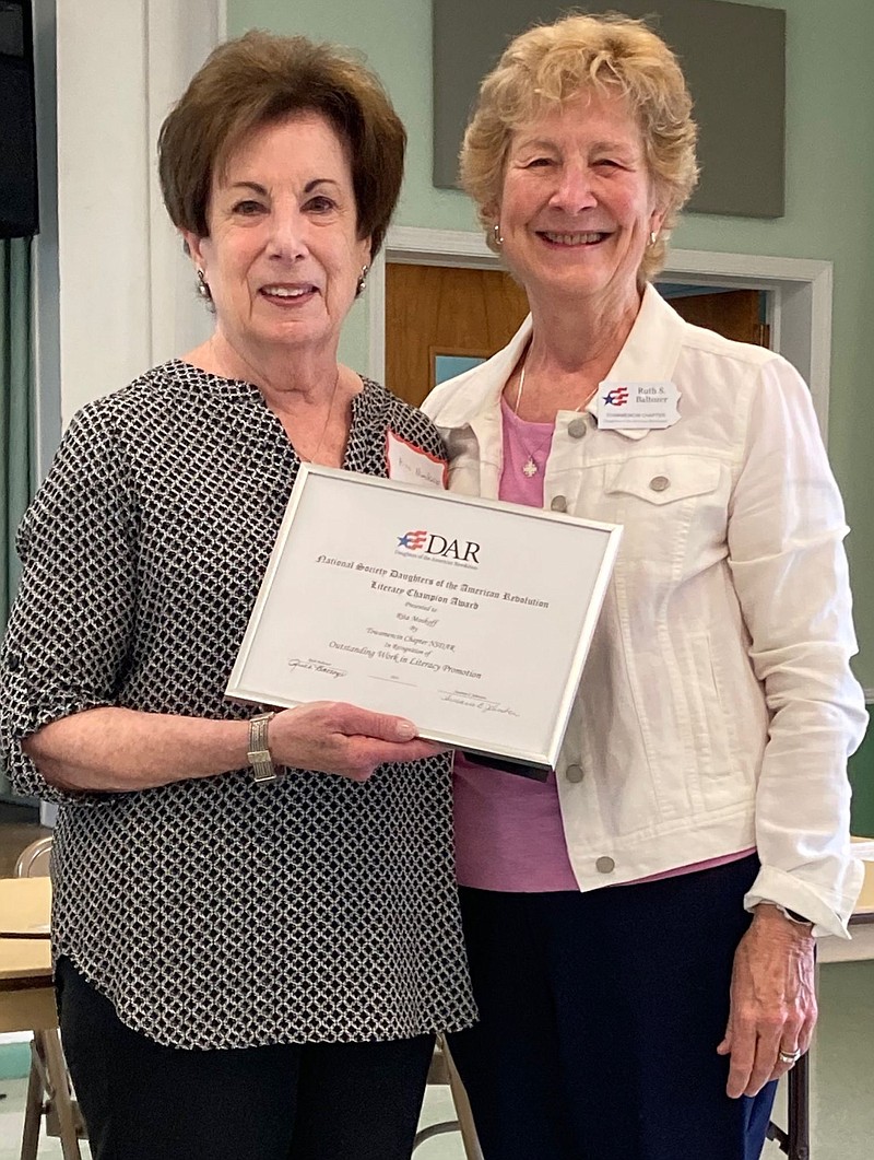 Rita Moskoff, left, receives the award from Towamencin Chapter member Ruth Baltozer. 