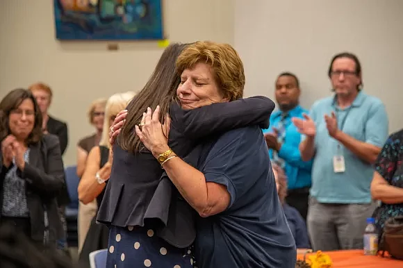 Retiring Children and Youth Director Marge McKeone receives a hug. 