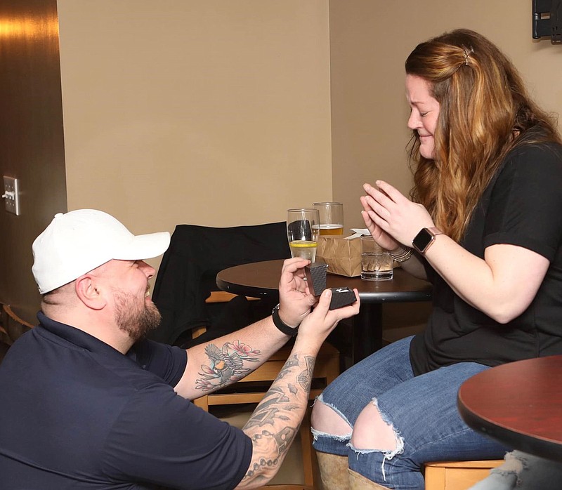 North Penn Now editor Keith Heffintrayer, left, surprises his girlfriend, Jaime Silverstein, right, with a marriage proposal at the end of Sunday's co