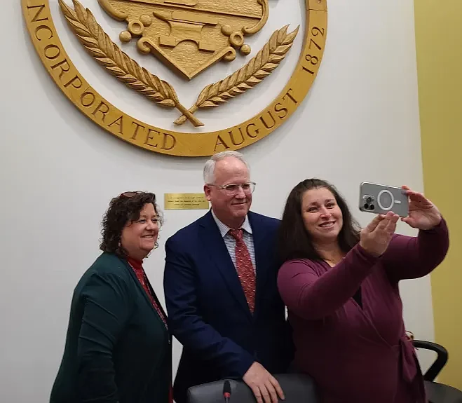 Lansdale borough councilwoman Carrie Hawkins takes a selfie with retiring council President Denton Burnell and council VP Mary Fuller, at the close of