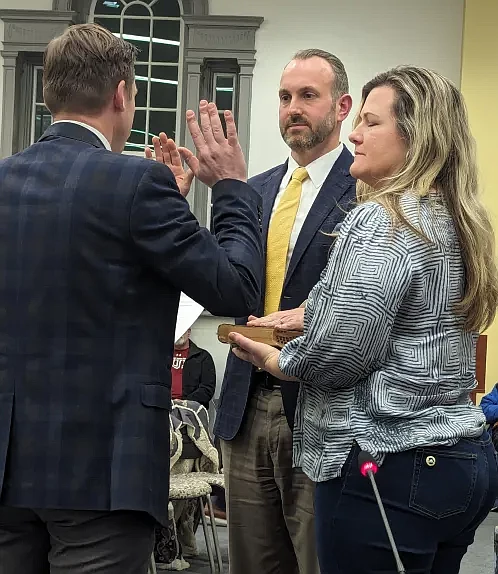 New Lansdale councilman Michael Yetter, center, receives his oath from Mayor Garry Herbert after being selected to fill a vacant seat from the town’s 