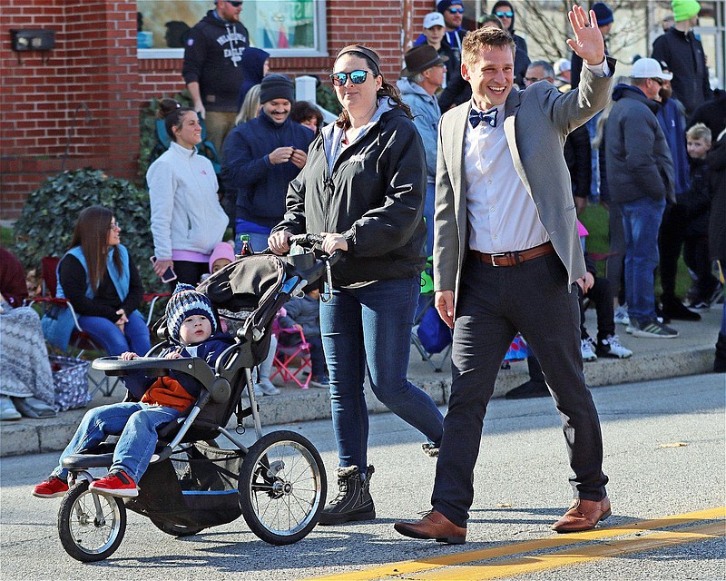 Lansdale Borough Mayor Garry Herbert waves as he marches with his wife, Megan, and son, Lucas, in the Mardi Gras Parade on Nov. 20. 