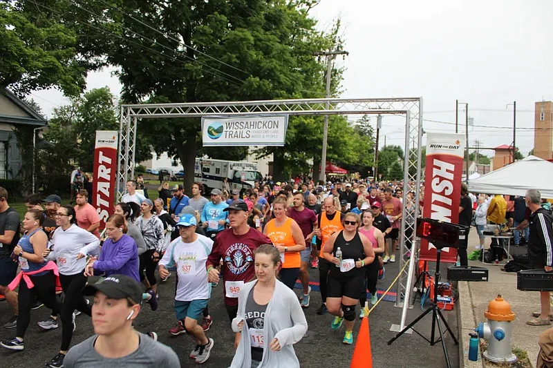 Runners pass through the starting and finish line of the Tex Mex Connection 5K Race for Open Space. 