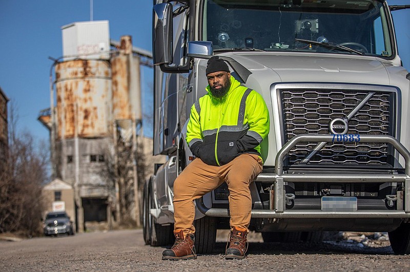 Anthony Williams, 40, of Harleysville, sits on the bumper of his rig while being interviewed. 