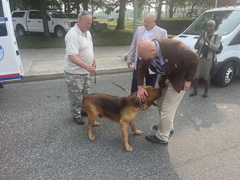 Sen. Doug Mastriano, R-Chambersburg, greets a police dog during an event at the Capitol building in Harrisburg, Pa. on June 6, 2023. 