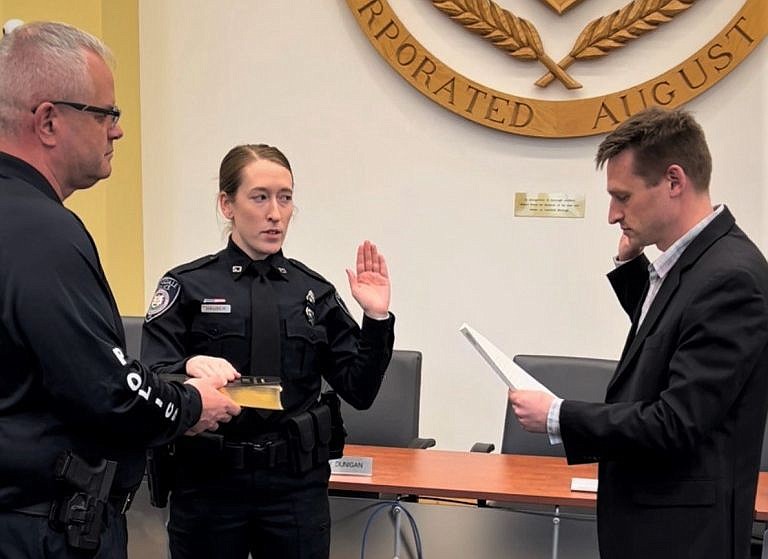 Officer Shannon Hauser, center, is sworn-in by Lansdale Mayor Garry Herbert, right, and Lansdale Police Chief Michael Trail, left. 