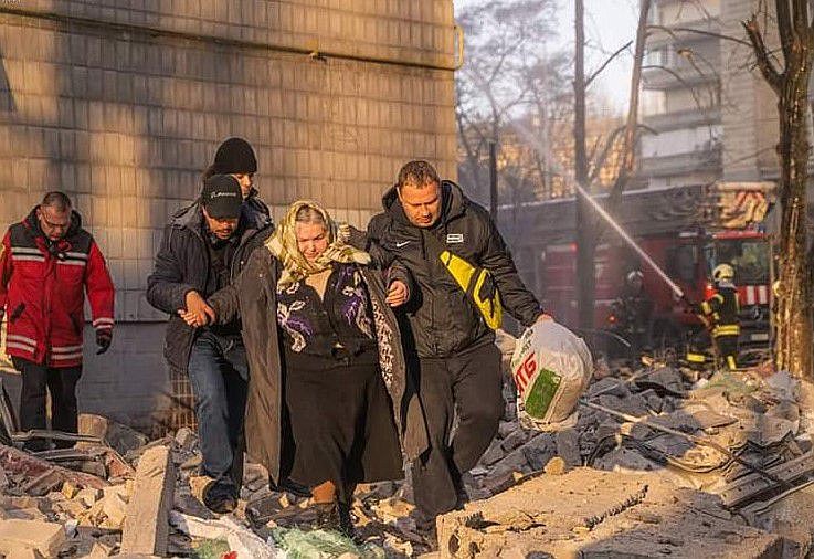 A woman is helped through rubble in the war zone in Ukraine last week. 