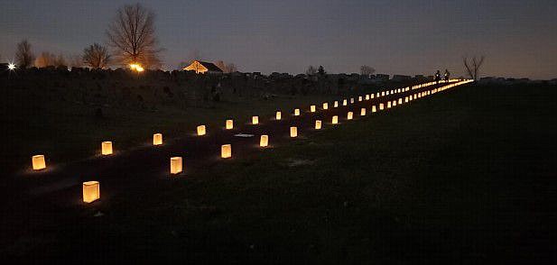 Event participants silently walk the path of Salford Mennonite’s cemetery, with tea light candles in hand. 