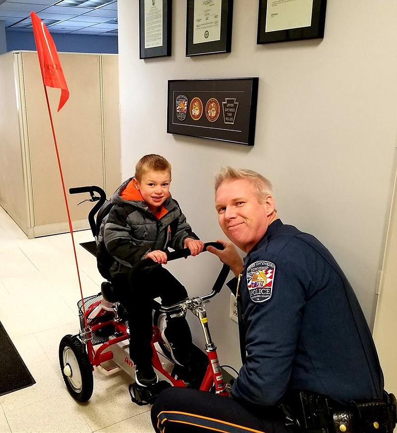 Jonah sits on his new trike. 