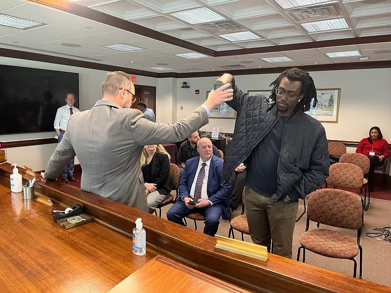 Kofi Osei, right, a Democrat candidate in the Towamencin Township Board of Supervisors race, selects a number on Nov. 30, 2023 as part of Montgomery C