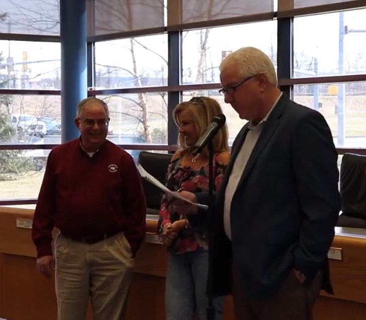 Larry Gregan, left, is presented with the award. 