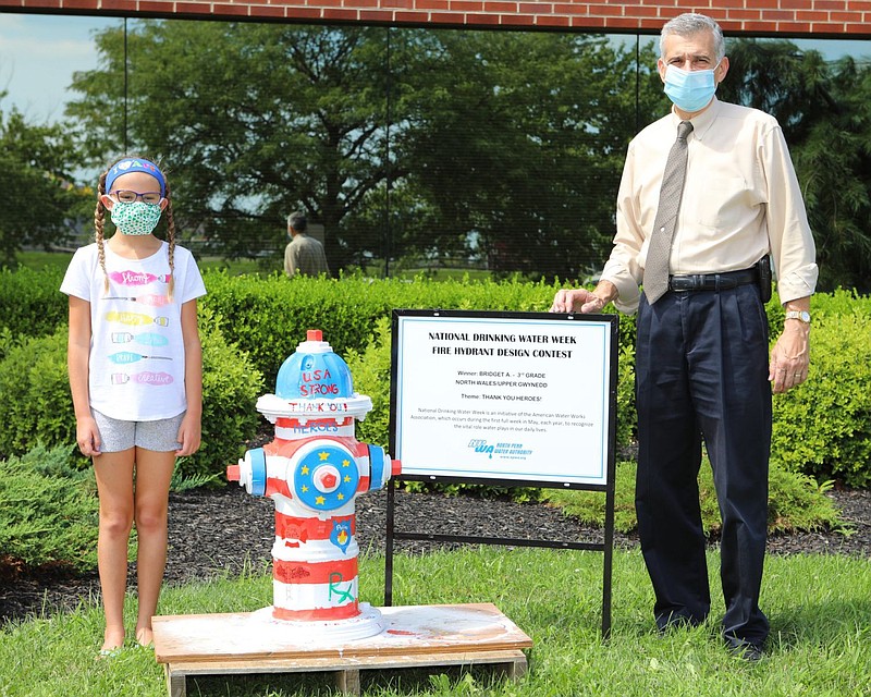 Bridget Adinolfi, left, and Anthony J. Bellitto, Jr., executive director of NPWA, right, in front of the hydrant Bridget painted in 2020. 