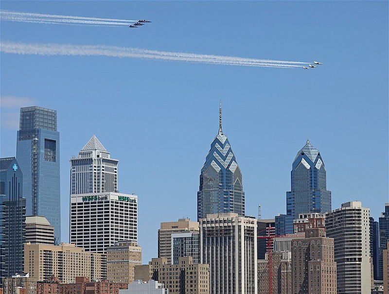 Thunderbirds and Blue Angels participate in a flyover of Philadelphia. 